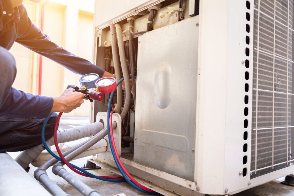 Technician checking an air conditioner unit.