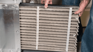 Changing filter in furnace.