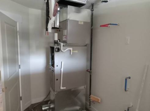 A newly installed indoor furnace system connected to ductwork.